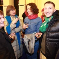 Reception after the premiere of the film: guests talking in a relaxed atmosphere