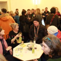 Reception after the film premiere: people in the foyer in a relaxed atmosphere