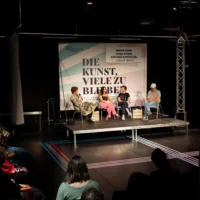 Somewhat from above, the picture shows the audience in rows in front of the brightly lit stage, on which Antonie Rietzschel, Mirna Funk, Tanja Krone and Ludwig Henne are engrossed in a discussion.